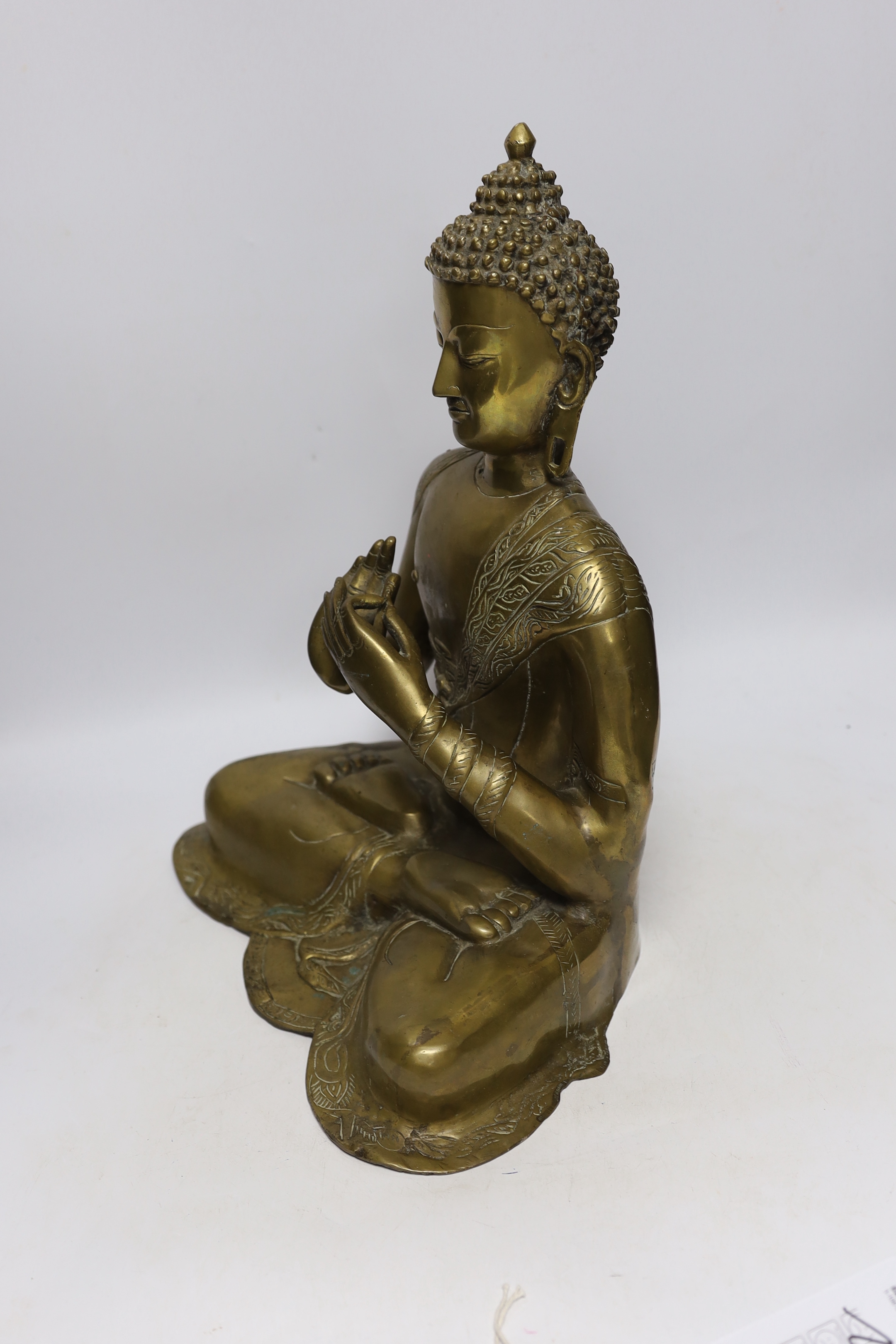 A Chinese or South East Asian bronze figure of seated buddha, 42cm high